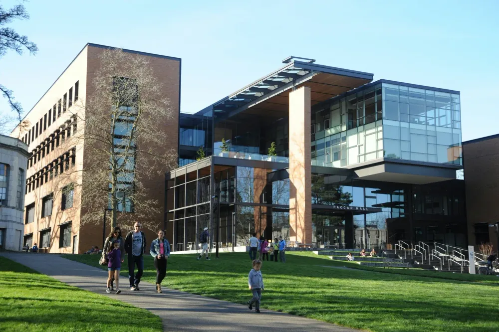 People walking past a modern commercial building.
