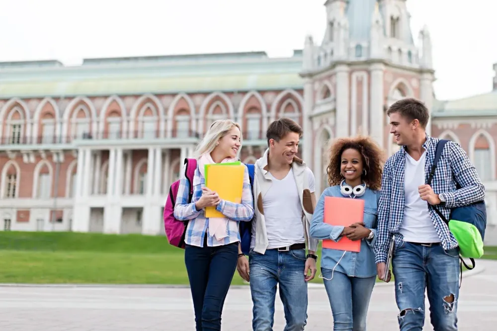 Students walking together outside a university building.
