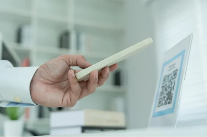 A customer scanning a QR code to leave real-time feedback.